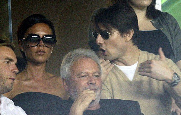 Actor Cruise talks to Beckham as they watch AC Milan play Los Angeles Galaxy during their friendly match in Carson