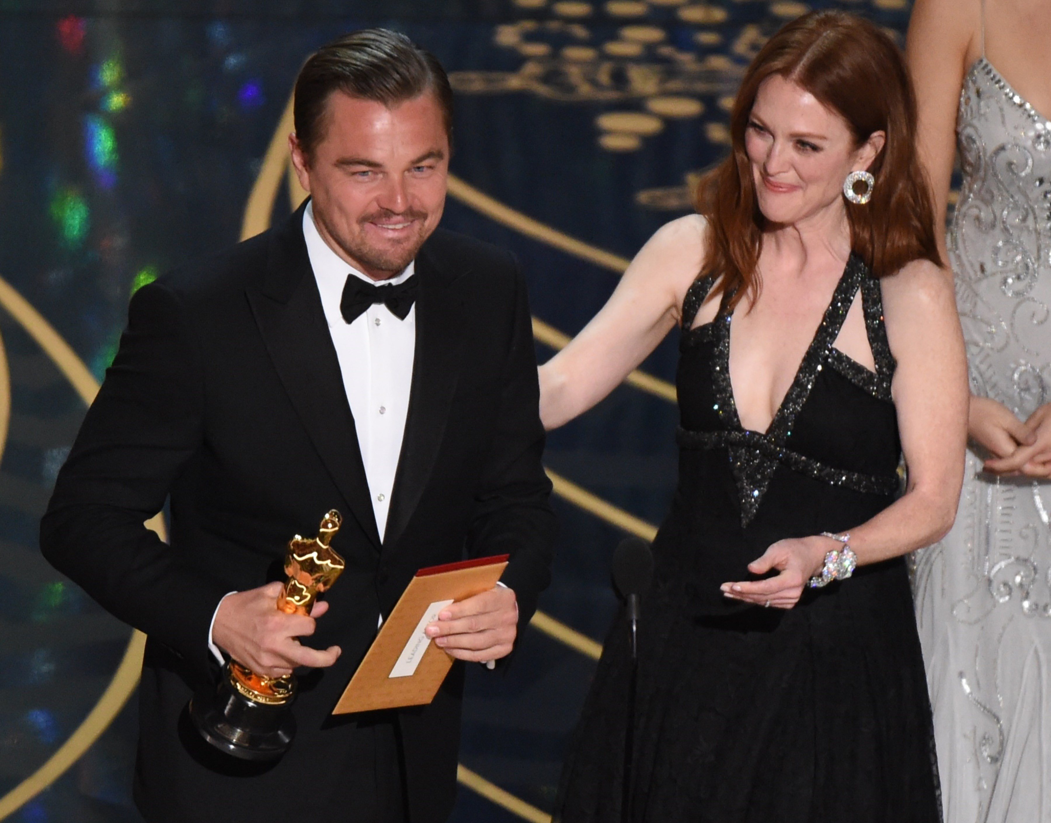 Actor Leonardo DiCaprio accepts the award for Best Actor in,The Revenant from actress Julianne Moore on stage at the 88th Oscars on February 28, 2016 in Hollywood, California. AFP PHOTO / MARK RALSTON 