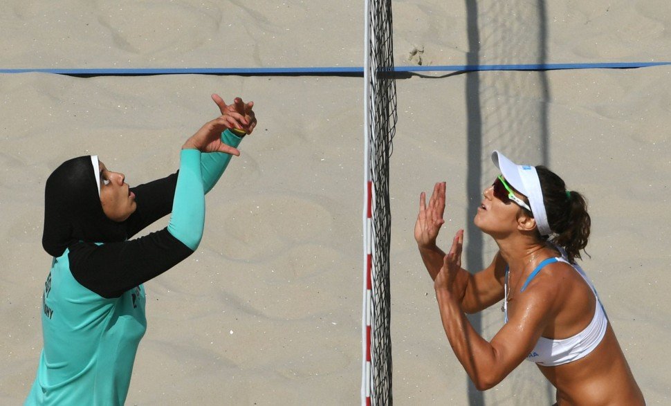Egypt's Doaa Elghobashy (L) and Italy's Laura Giombini prepare to jump for the ball during the women's beach volleyball qualifying match between Italy and Egypt at the Beach Volley Arena in Rio de Janeiro on August 9, 2016, for the Rio 2016 Olympic Games. / AFP PHOTO / Yasuyoshi Chiba Egypt's Doaa Elghobashy (L) and Italy's Laura Giombini prepare to jump for the ball during the women's beach volleyball qualifying match between Italy and Egypt at the Beach Volley Arena in Rio de Janeiro on August 9, 2016, for the Rio 2016 Olympic Games. / AFP PHOTO / Yasuyoshi Chiba