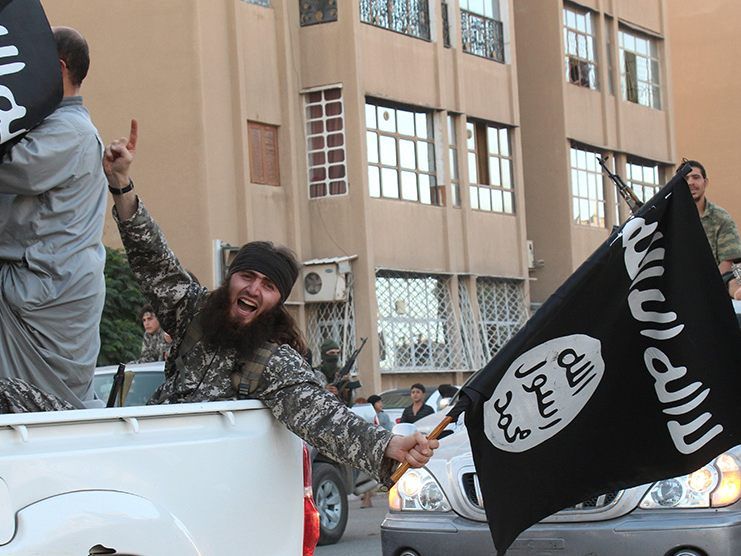 This file photo shows an image made available by Jihadist media outlet Welayat Raqa on June 30, 2014, allegedly showing a member of the IS (Islamic state) group parading in a street in the northern rebel-held Syrian city of Raqa.