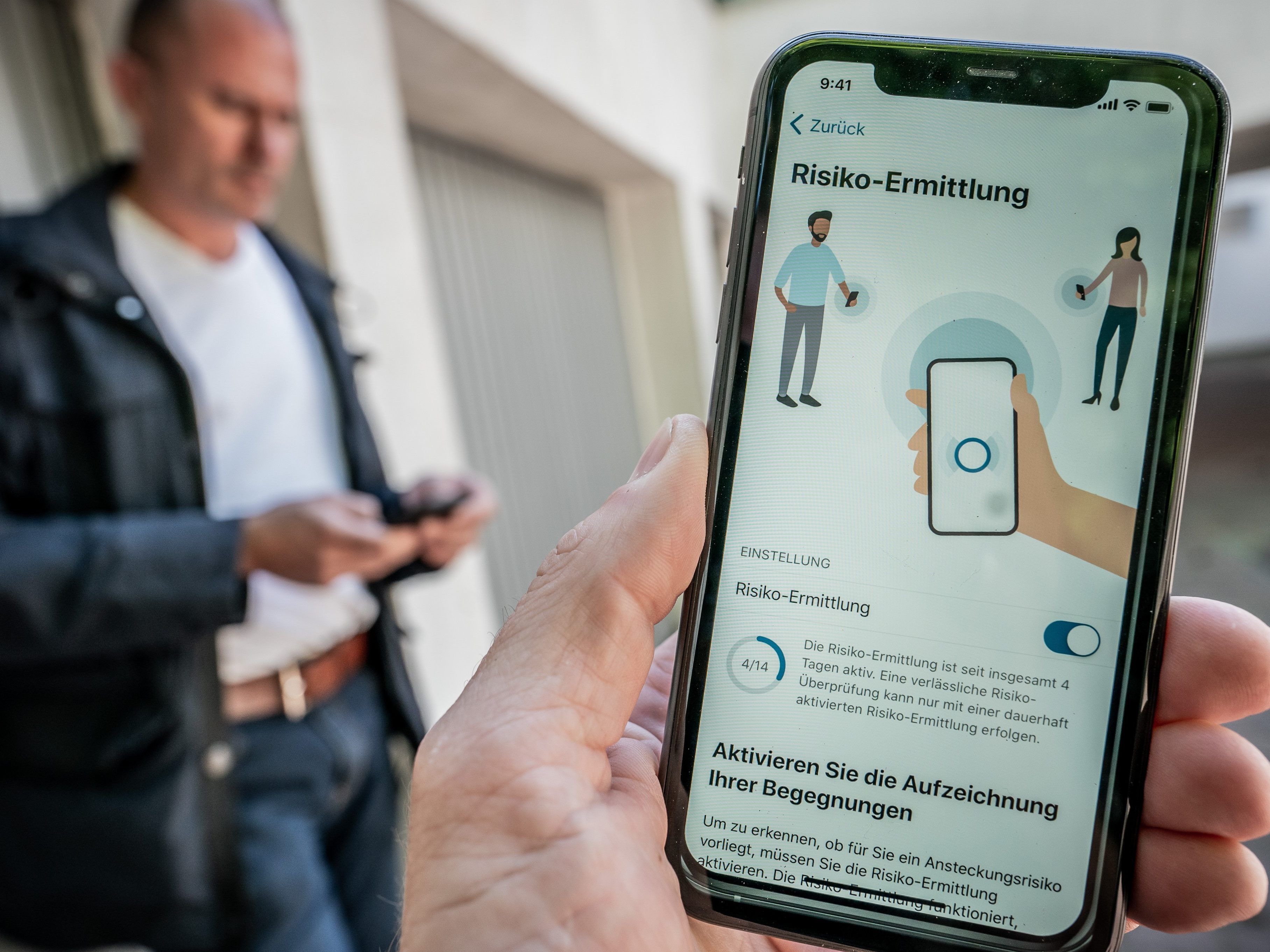 Ein Mann schaut sich die Corona-Warn-App in der Entwickler-Version auf seinem Smartphone an.