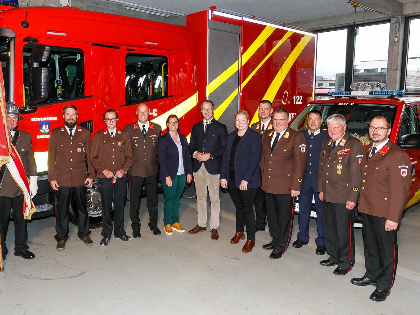 Mitglieder der Rankweiler Feuerwehr und politische Vertreter*innen vor dem neuen Versorgungsfahrzeug mit Containeraufbau Mitglieder der Rankweiler Feuerwehr und politische Vertreter*innen vor dem neuen Versorgungsfahrzeug mit Containeraufbau
