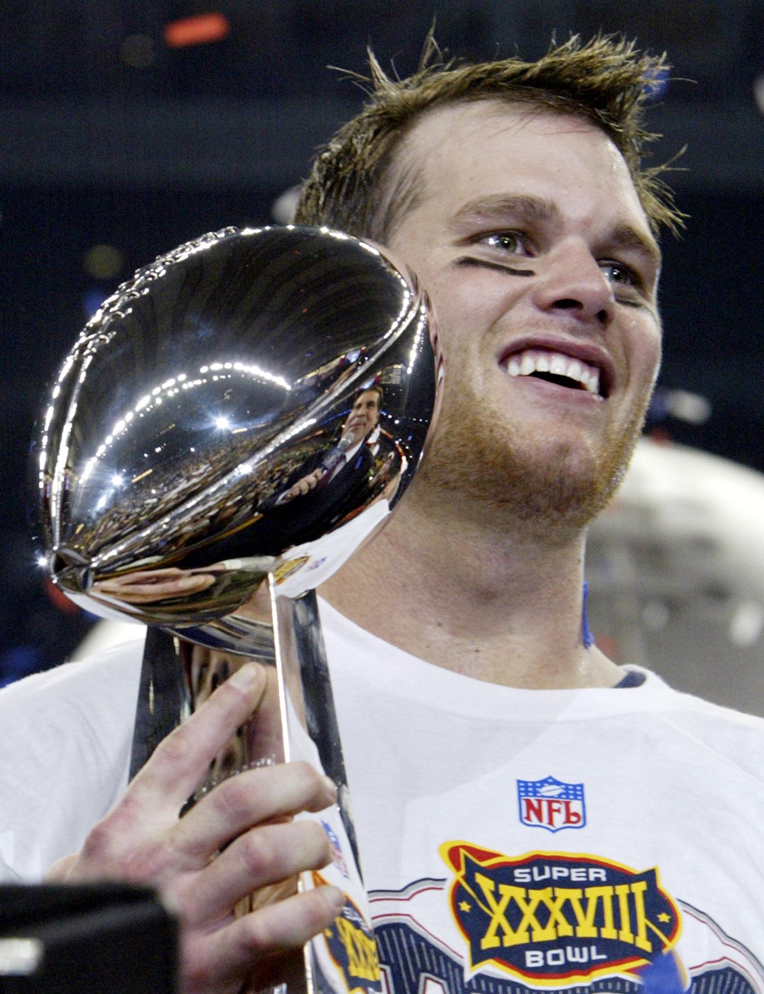 Quarterback Tom Brady von den New England Patriots hält die Vince Lombardi-Trophäe nach dem Gewinn des Super Bowl XXXVIII im Reliant Stadium in Houston, Texas. Quarterback Tom Brady von den New England Patriots hält die Vince Lombardi-Trophäe nach dem Gewinn des Super Bowl XXXVIII im Reliant Stadium in Houston, Texas.