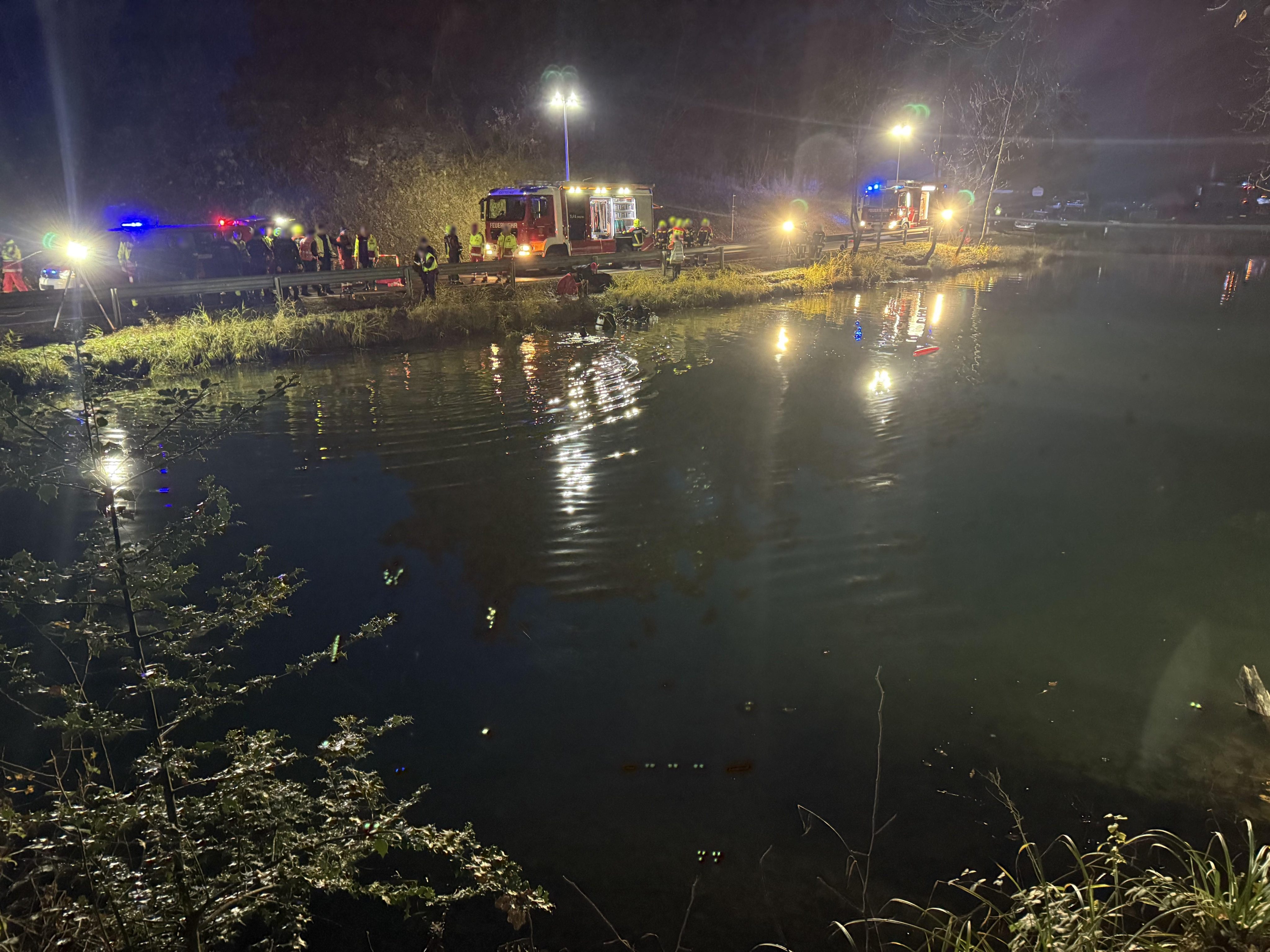 Polizei, Feuerwehr und Wasserrettung am Ufer – Taucher im Einsatz zur Bergung des Fahrzeugs.